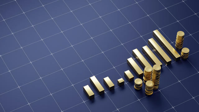 Golden financial chart stacks of gold coins on dark navy floor with a grid pattern 