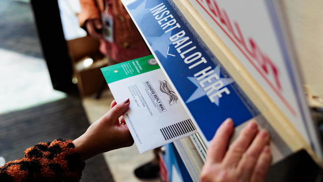 A voter puts their ballot into a drop box in Pennsylvania 