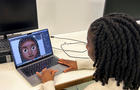 Designer Vanita Brown looks at the final version of one of the Afro hair emojis at the Concorde Youth Club in Hackney, east London 