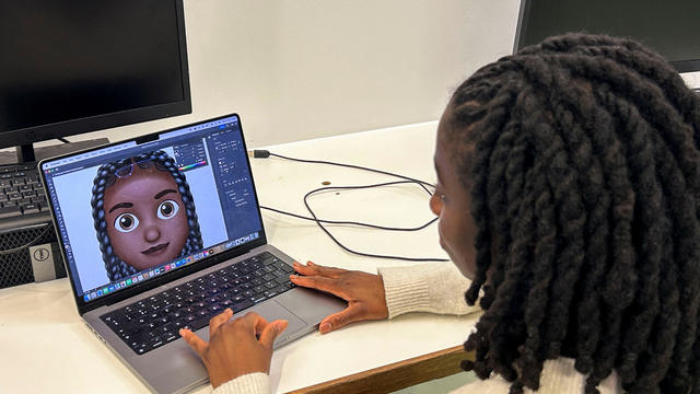 Designer Vanita Brown looks at the final version of one of the Afro hair emojis at the Concorde Youth Club in Hackney, east London 