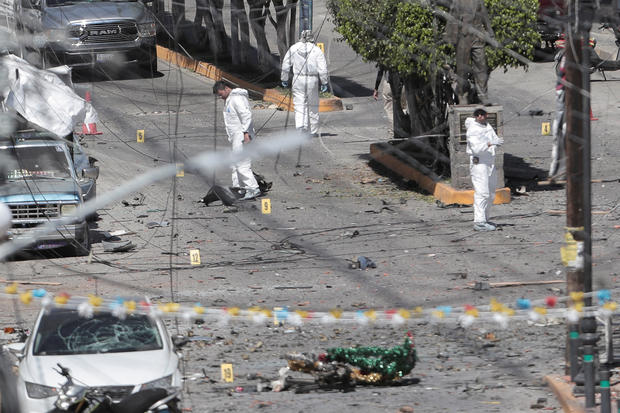 Federal forces work the scene of a car bomb in Jerecuaro 