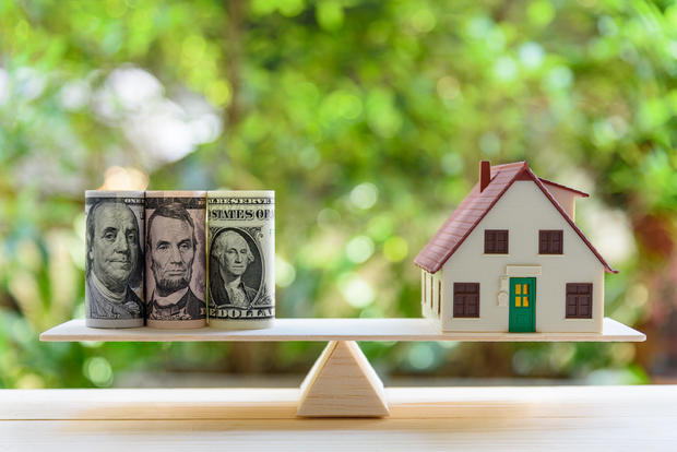 Home indebtedness / reverse owe aliases transforming assets into rate conception : House model, US dollar notes connected a elemental equilibrium scale, depicts a homeowner aliases a borrower turns properties / residence into rate 