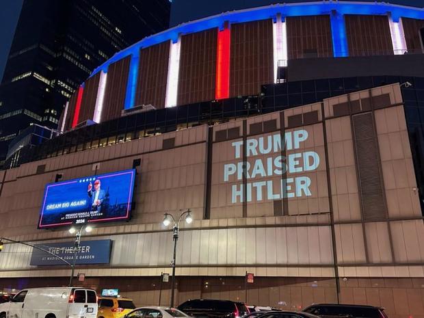 Message saying "Trump Praised Hitler" is projected by the DNC on the side of Madison Square Garden in New York City during a Trump rally 