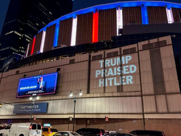 Message saying "Trump Praised Hitler" is projected by the DNC on the side of Madison Square Garden in New York City during a Trump rally
