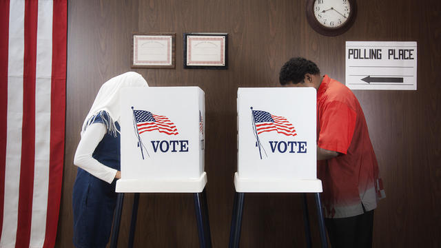 Voters voting in polling place 