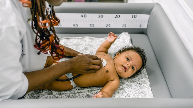 Pediatrician examining baby 