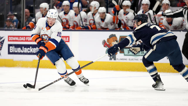 Damon Severson #78 of the Columbus Blue Jackets knocks the puck away form Simon Holmstrom #10 of the New York Islanders during the second period of the game at Nationwide Arena on October 30, 2024 in Columbus, Ohio. 