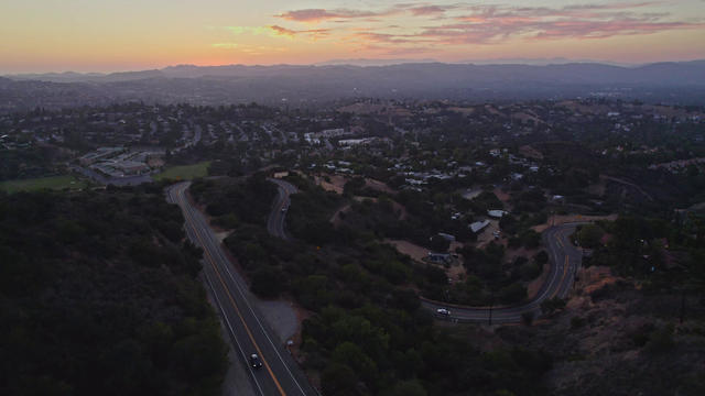 Sweeping turns of a road in the mountains during the sunset. 