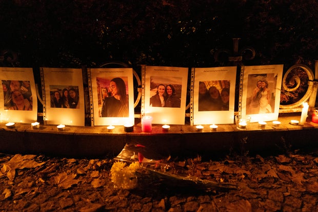 Photos showing Mackenzie Michalski, an 31-year-old American tourist who was murdered while on vacation, hang at a candlelight vigil in Budapest, Hungary, Saturday, Nov. 9, 2024