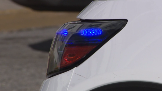 A Baltimore Police cruiser with its lights on 