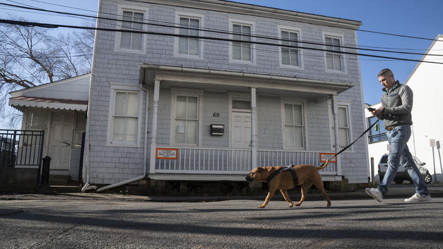 ANNAPOLIS MD - DECEMBER 13, 2022  A man walks his dog in front 