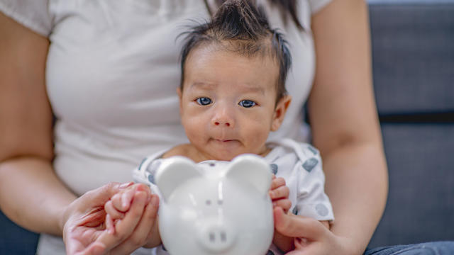 Mother with baby and piggy bank 