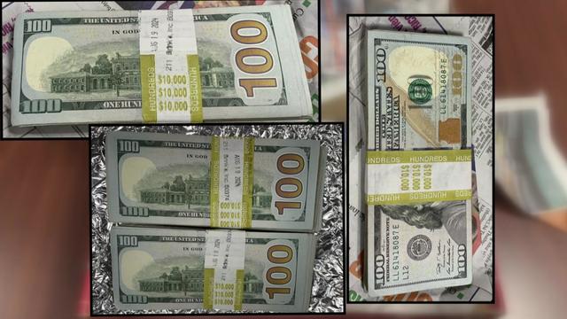 Four stacks of $10,000 in cash placed inside a box. 