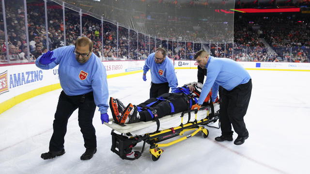 Referee Mitch Dunning is stretchered off the ice after an injury during the first period of an NHL hockey game between the Philadelphia Flyers and the Colorado Avalanche 