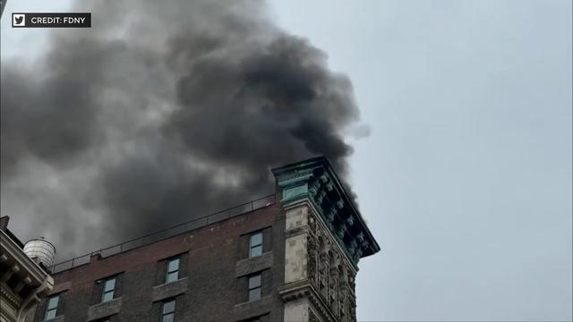 Dark smoke pours from the roof of a building in SoHo. 