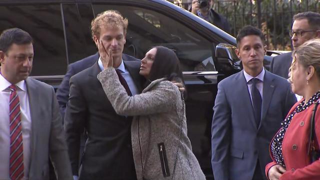 Daniel Penny stands outside a vehicle with his mother, Gina. 