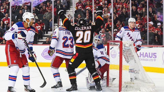 Blake Coleman #20 watches the shot of Connor Zary #47 of the Calgary Flames fly past Igor Shesterkin #31 of the New York Rangers during the third period of an NHL game at Scotiabank Saddledome on November 21, 2024 in Calgary, Alberta, Canada. 