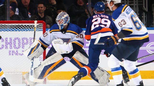 Jordan Binnington #50 of the St. Louis Blues defends against Brock Nelson #29 of the New York Islanders during the first period at UBS Arena on November 23, 2024 in Elmont, New York. 