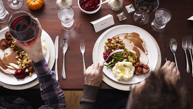 Overhead of two men eating holiday meal 