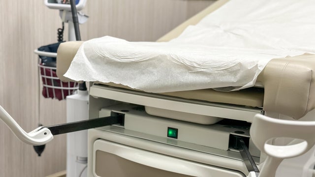 patient examination chair with medical stirrups in gynecologist office 