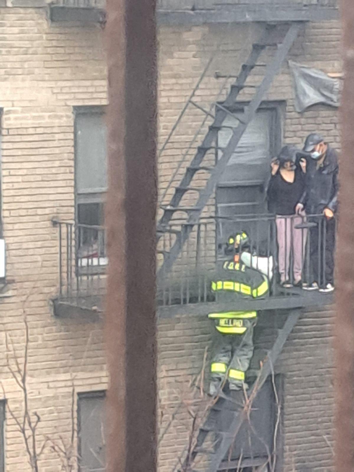 Photos capture rescue of child from Inwood apartment fire in NYC - CBS ...