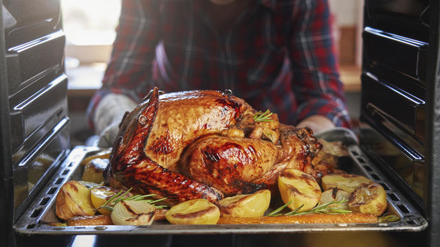 Turkey, stuffing, and cranberry dishes on table. 