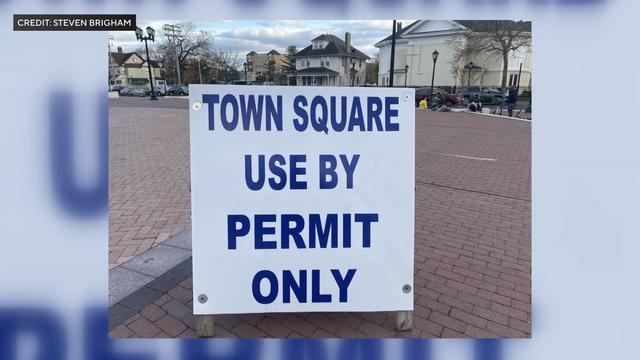 A large sign reading "Town square use by permit only" in Lakewood town square. 