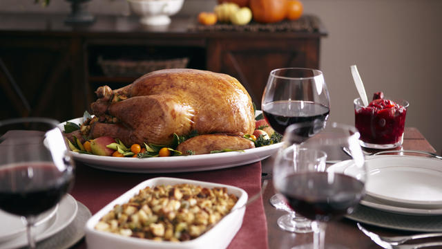 Turkey, stuffing, and cranberry dishes on table. 