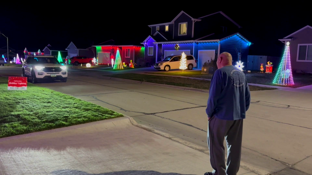 An Iowa man decorated neighbors' homes to celebrate his wife's love of Christmas