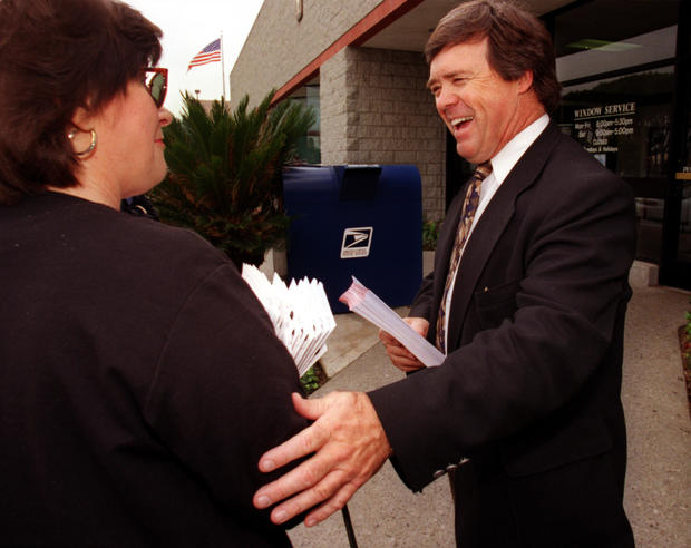 County Supervisor candidate Mike Morgan, right, talks to Judy Winters while stumping for votes at a 