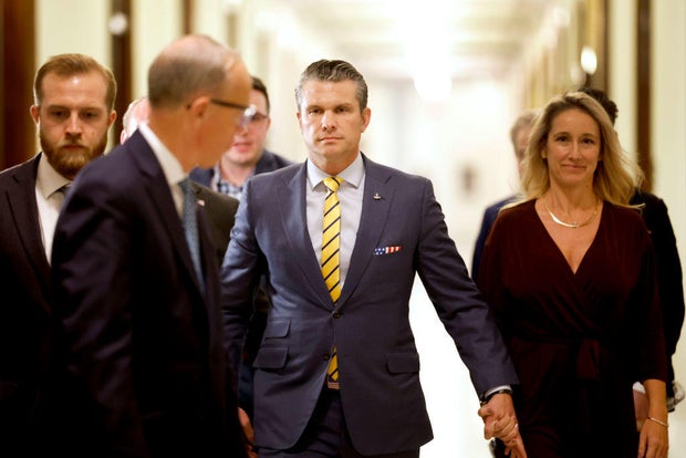 Pete Hegseth and his wife Jennifer Rauchet walk through the Russell Senate Office building on Capitol Hill on Dec. 3, 2024, in Washington, D.C.