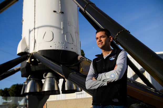 Inspiration4 mission commander Jared Isaacman, founder and CEO of Shift4 Payments, poses for a portrait in front of the recovered first stage of a Falcon 9 rocket at SpaceX on February 2, 2021, in Hawthorne, California.