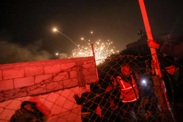 People run for cover as an explosion from an Israeli strike occurs near a makeshift camp for displaced Palestinians, in Mawasi Khan Yunis in the southern Gaza Strip on Dec. 4, 2024, amid the ongoing war between Israel and the Hamas militant group. 