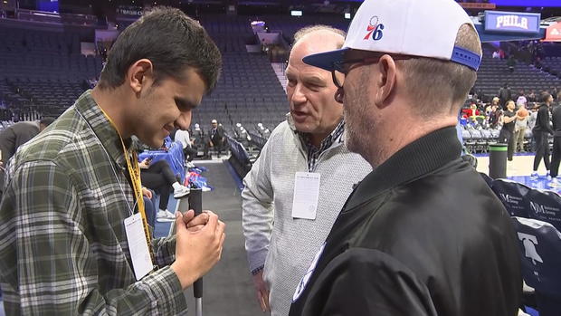 Allan Wylie speaks to people at a Sixers game 