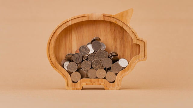 Saving coins in a piggy bank, financial income and financial investment, cash flow from working to earn money 