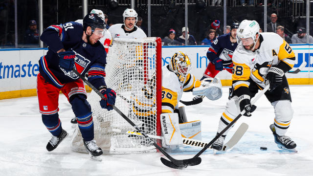 Reilly Smith #91 of the New York Rangers skates with the puck against Kris Letang #58 of the Pittsburgh Penguins at Madison Square Garden on December 6, 2024 in New York City. 