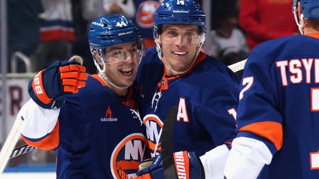 Bo Horvat #14 of the New York Islanders (c) celebrates his goal at 18:55 of the second period against the Carolina Hurricanes and is joined by Jean-Gabriel Pageau #44 (l) at UBS Arena on December 07, 2024 in Elmont, New York. 