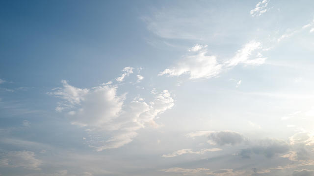 The light illuminates the clouds in the sky 