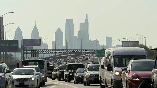 Traffic moves on a highway with the Philadelphia skyline in the background 