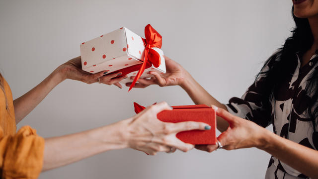 Anonymous Female Friends Exchanging Gifts 