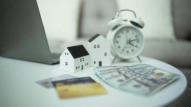 Concept of buying a house with credit card and cash 