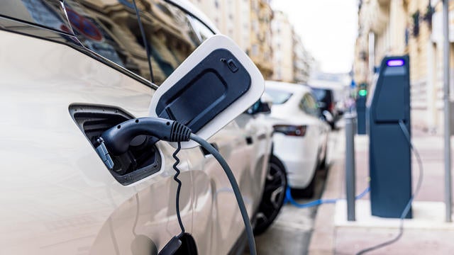 Electric car charging at the electric station on the street 