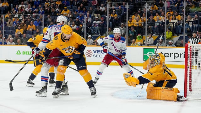 Juuse Saros #74 of the Nashville Predators makes a glove save against the New York Rangers during an NHL game at Bridgestone Arena on December 17, 2024 in Nashville, Tennessee. 