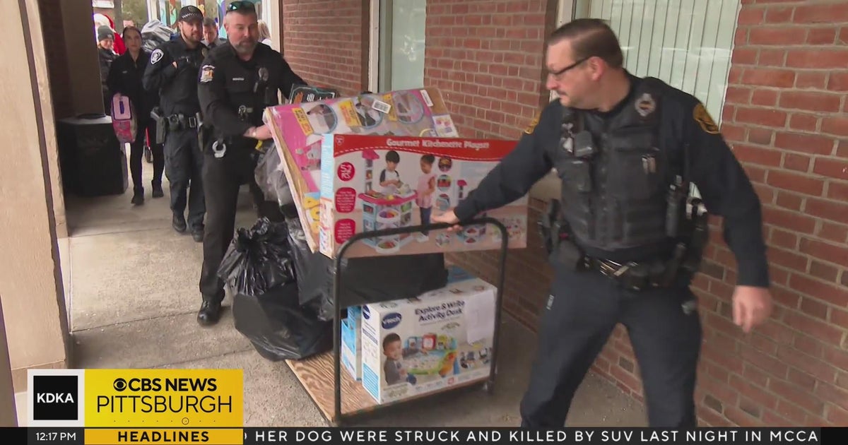 Officers deliver gifts to The Day School as part of Presents with ...