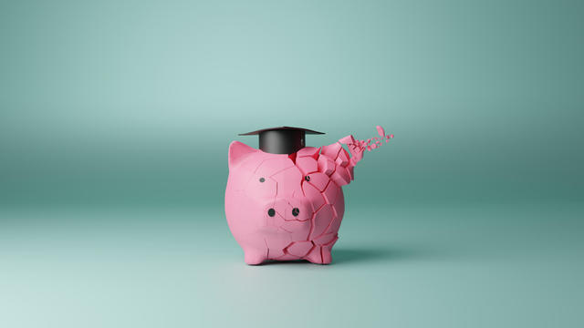 Student loan piggy bank crack concept 