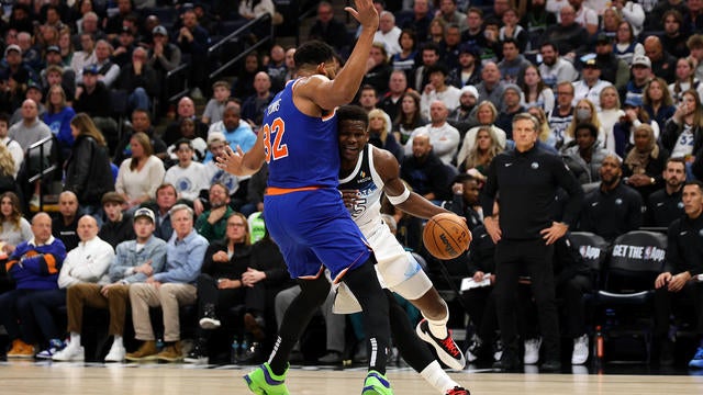 Anthony Edwards #5 of the Minnesota Timberwolves drives to the basket against Karl-Anthony Towns #32 of the New York Knicks in the second quarter at Target Center on December 19, 2024 in Minneapolis, Minnesota. 