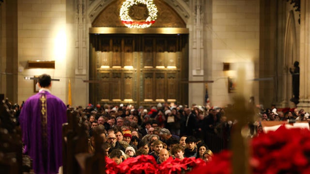 Father Luigi Portarulo (L), Parochial Vicar, leads a Christmas Eve mass at St. Patrick's Cathedral in New York City on December 24, 2024. 