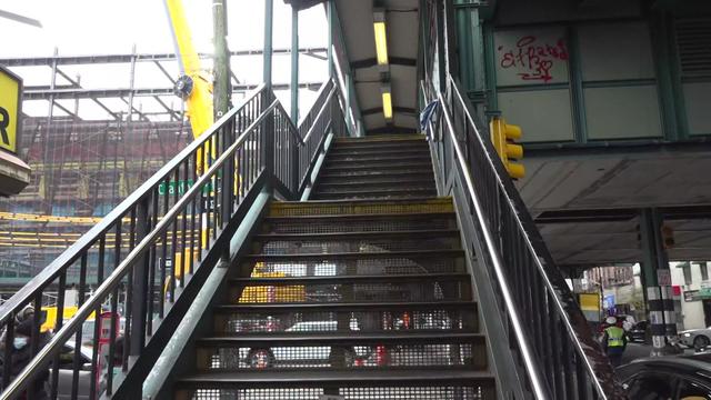 A flight of stairs leading up to the mezzanine level of a subway station in the Bronx 