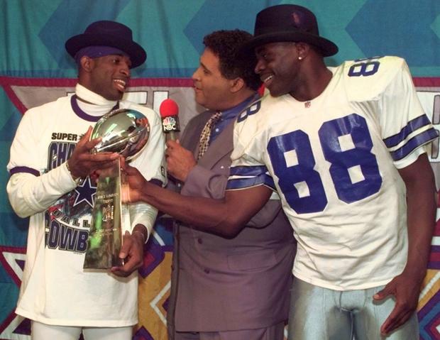 Greg Gumbel interviews Dallas Cowboys cornerback Deion Sanders, left, and running back Michael Irvin 