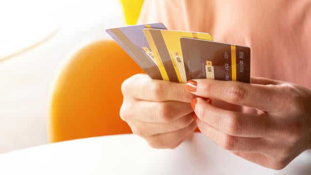 Cropped shot view of female hands holding her credit cards. 